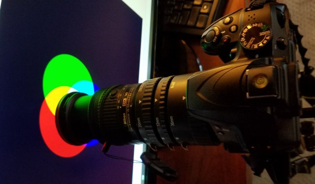 This photograph shows the setup used to capture the individual dots on the screen.